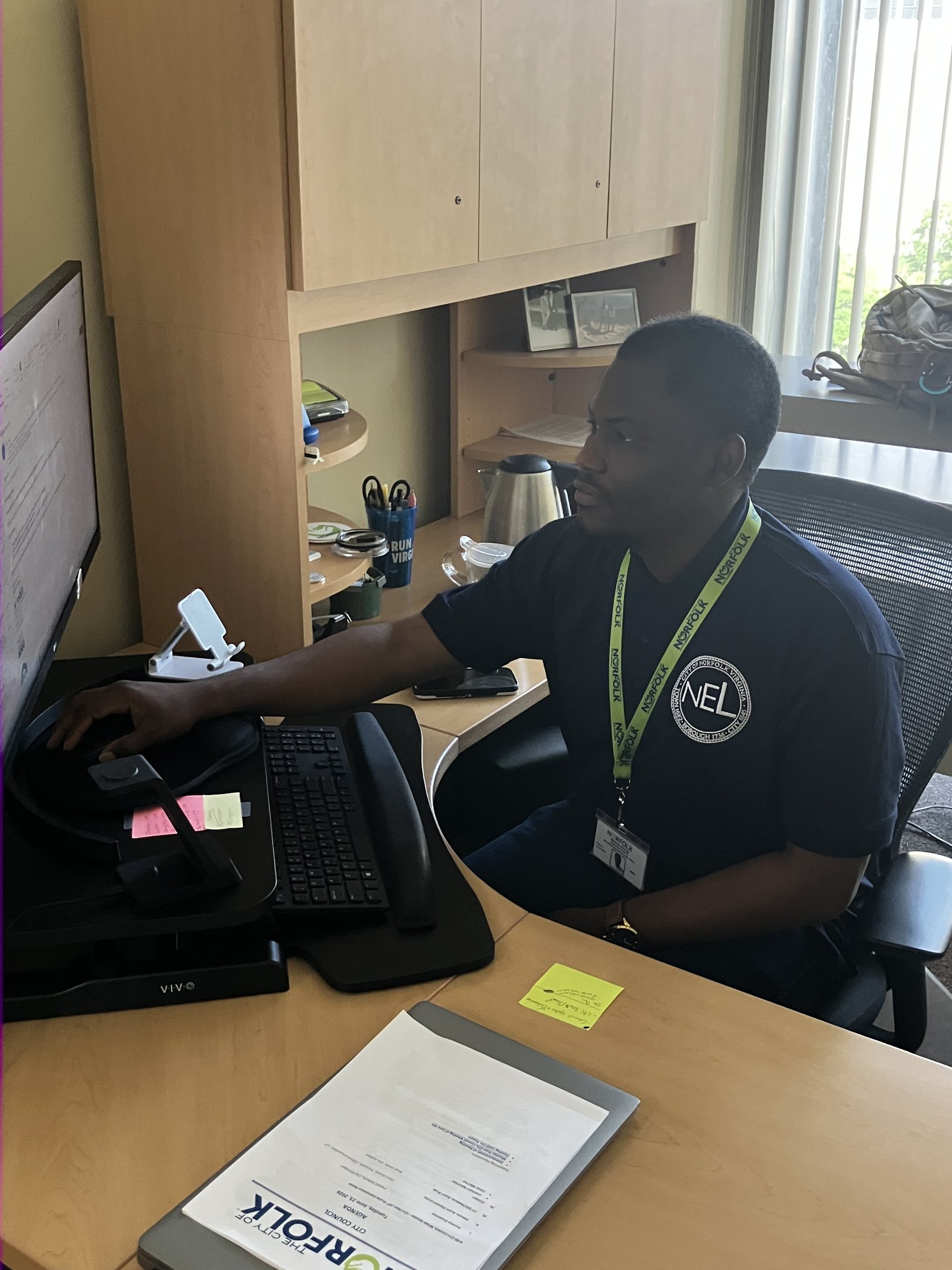 Michael Okoroh working at a City of Norfolk workstation